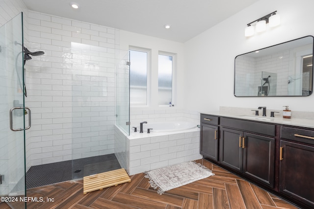 bathroom with vanity and plus walk in shower