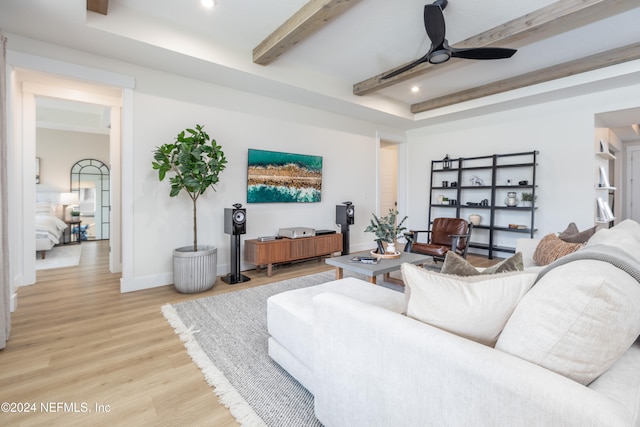 living room featuring ceiling fan, beam ceiling, and wood-type flooring