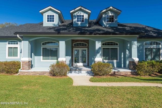 cape cod house with a porch and a front lawn