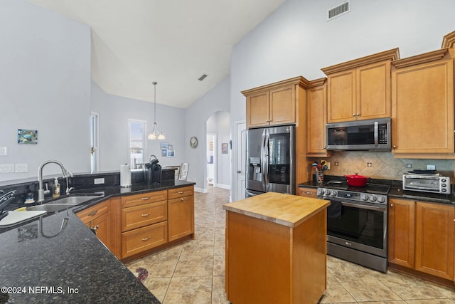 kitchen featuring stainless steel appliances, sink, high vaulted ceiling, butcher block countertops, and a kitchen island