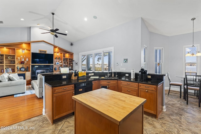 kitchen with ceiling fan with notable chandelier, sink, decorative light fixtures, dishwasher, and a kitchen island