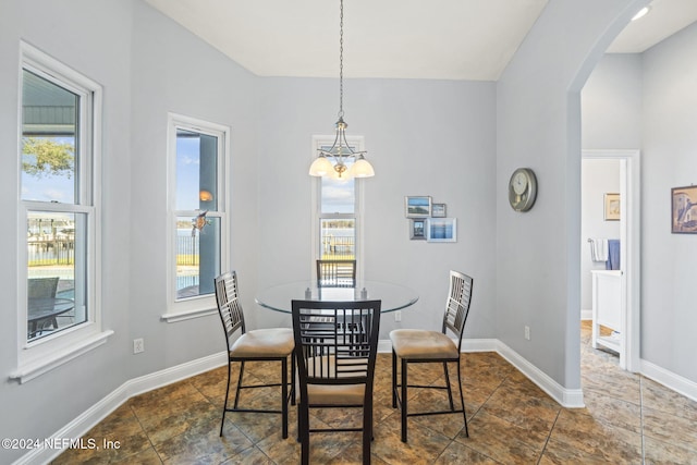 dining room with a wealth of natural light and a notable chandelier