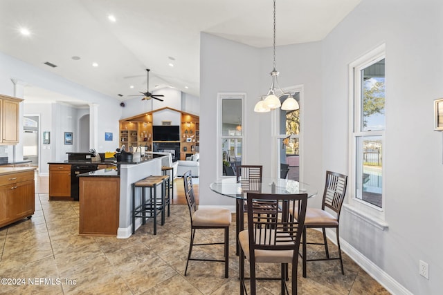 dining space featuring high vaulted ceiling and ceiling fan