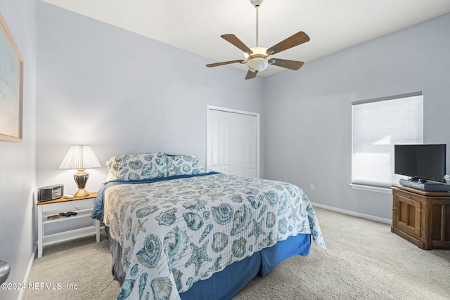 carpeted bedroom featuring a closet and ceiling fan