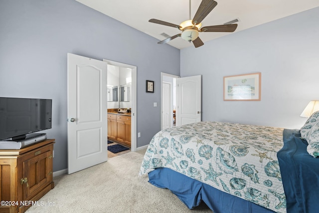 carpeted bedroom featuring ensuite bathroom and ceiling fan