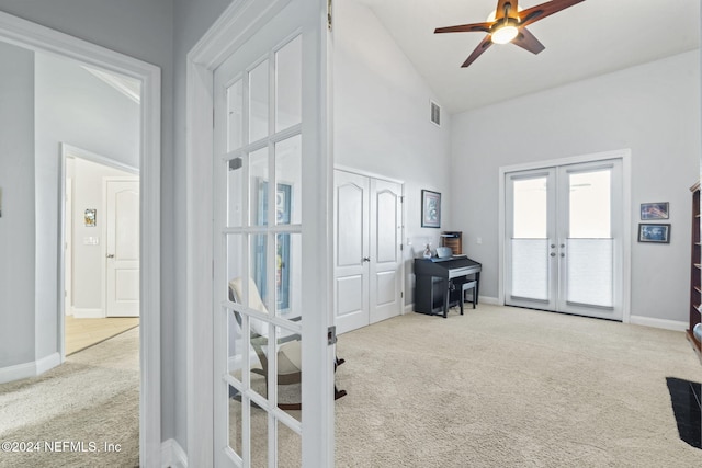 miscellaneous room featuring ceiling fan, light carpet, high vaulted ceiling, and french doors