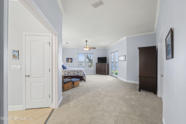 bedroom featuring ceiling fan, light colored carpet, and crown molding