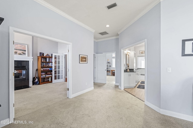 hall with light carpet and crown molding