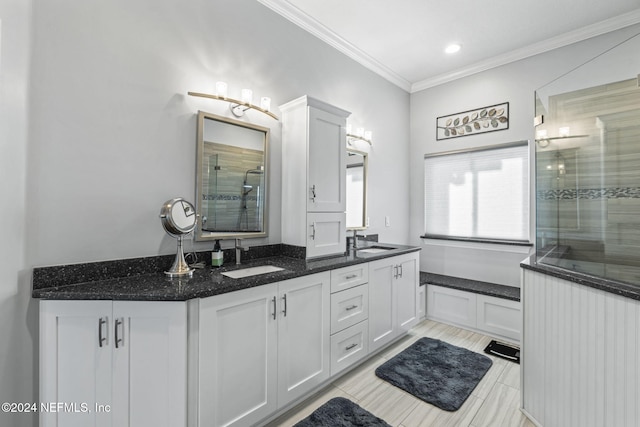 bathroom featuring vanity, an enclosed shower, and crown molding