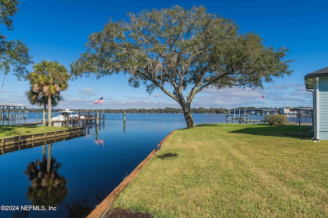 exterior space with a water view and a yard