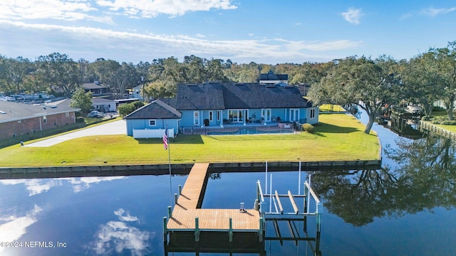 dock area featuring a patio, a water view, and a lawn