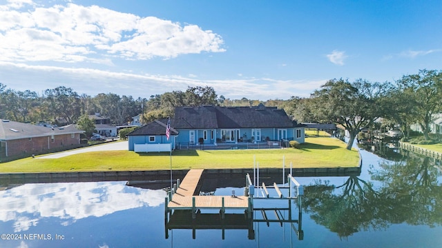 view of dock featuring a lawn and a water view