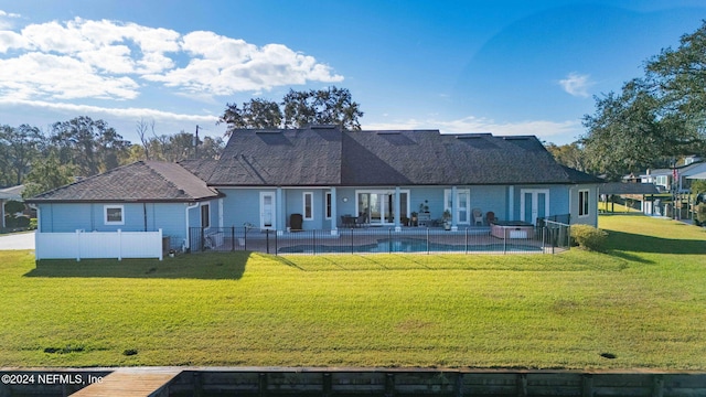 back of house with a patio area and a lawn