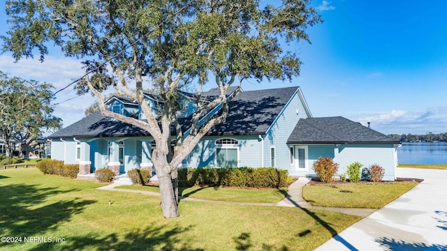 view of front of home featuring a water view and a front lawn