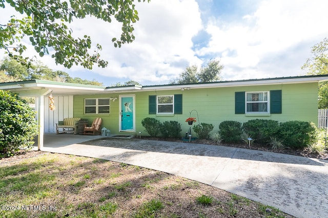 single story home featuring a carport