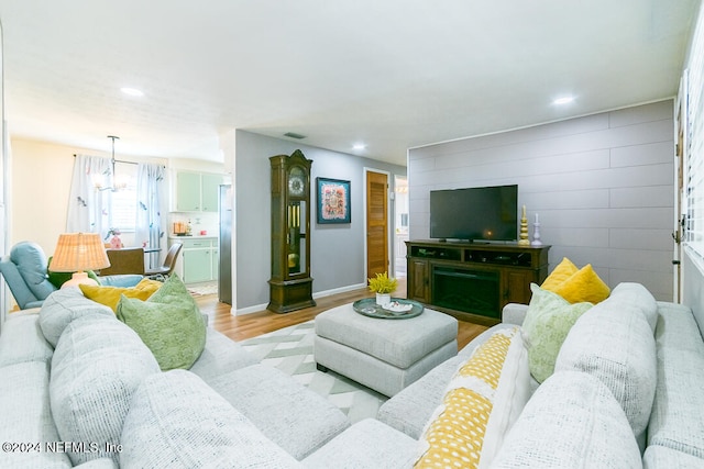 living room featuring light hardwood / wood-style floors and a notable chandelier