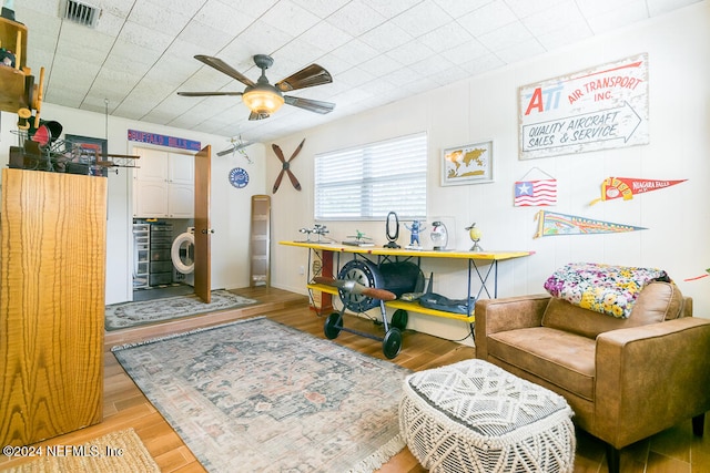 living area with light hardwood / wood-style flooring and ceiling fan