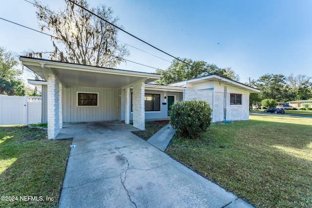 single story home with a front yard and a carport