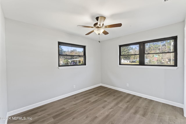 empty room featuring ceiling fan and hardwood / wood-style floors