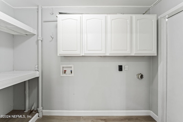 clothes washing area with cabinets, electric dryer hookup, dark hardwood / wood-style flooring, and hookup for a washing machine