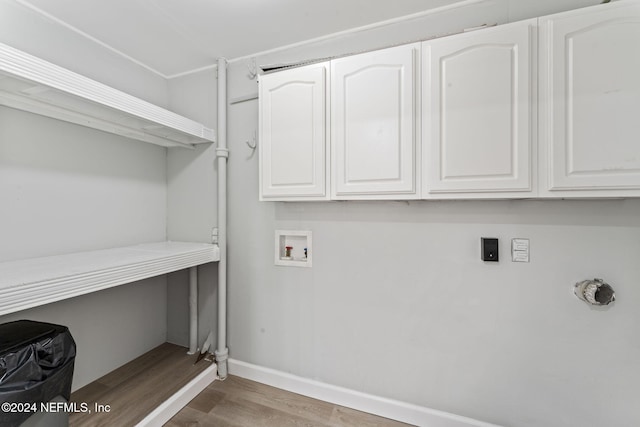 laundry area with washer hookup, hookup for an electric dryer, cabinets, and hardwood / wood-style floors