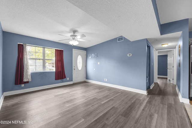 interior space with ceiling fan, wood-type flooring, and a textured ceiling