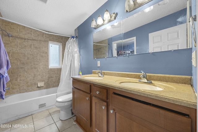 full bathroom with shower / bath combo, vanity, tile patterned flooring, toilet, and a textured ceiling