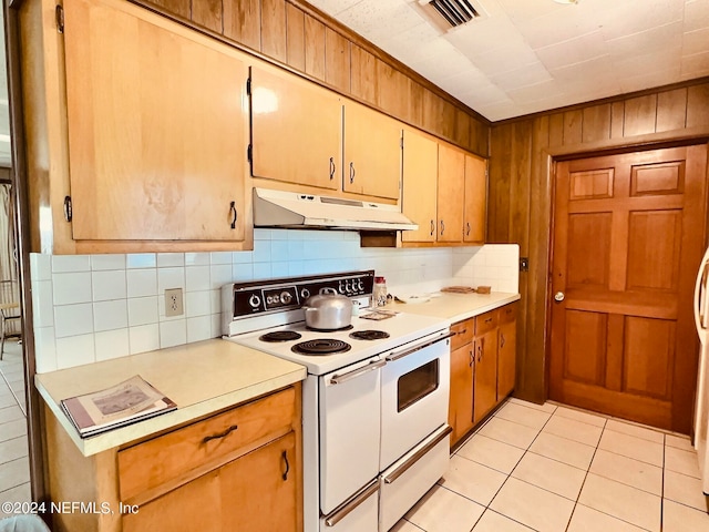 kitchen featuring decorative backsplash, white electric range, and light tile patterned floors