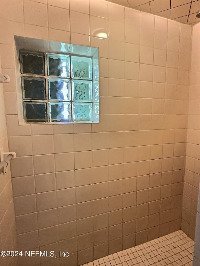 bathroom with a tile shower