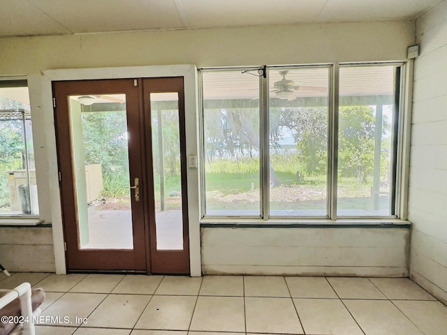 doorway to outside with a wealth of natural light and light tile patterned floors