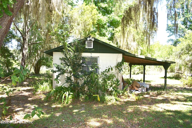 view of side of home featuring a carport