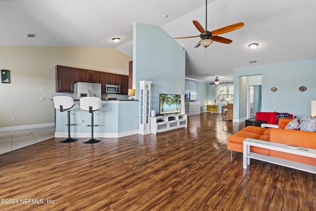 living room featuring ceiling fan, hardwood / wood-style floors, and high vaulted ceiling