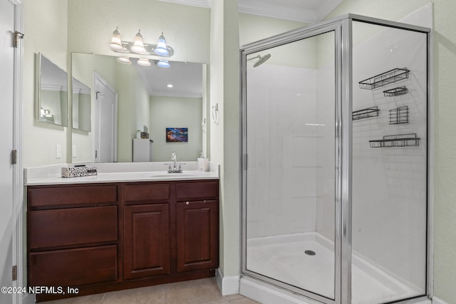 bathroom with tile patterned flooring, vanity, ornamental molding, and walk in shower