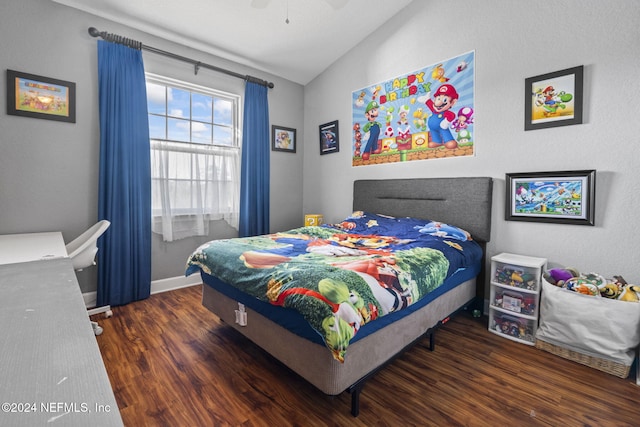 bedroom with ceiling fan, dark wood-type flooring, and vaulted ceiling