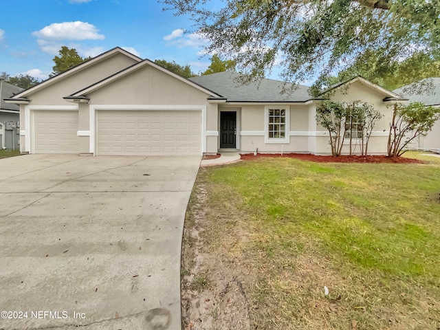 ranch-style home with a garage and a front lawn