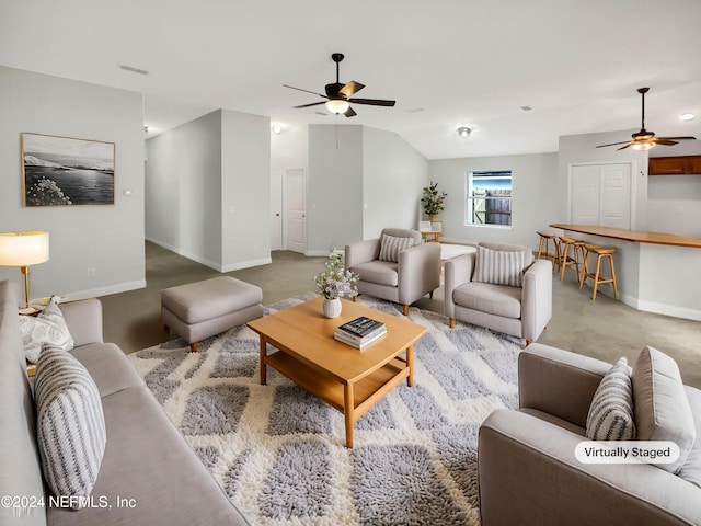 carpeted living room with ceiling fan and lofted ceiling