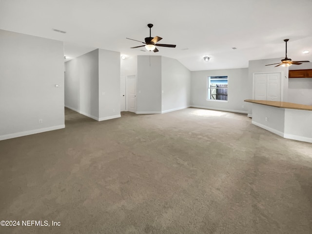 unfurnished living room featuring carpet, ceiling fan, and lofted ceiling