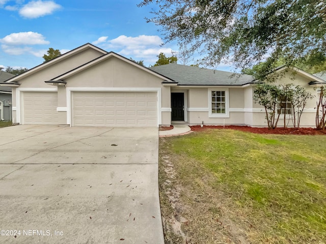 single story home with a garage and a front yard