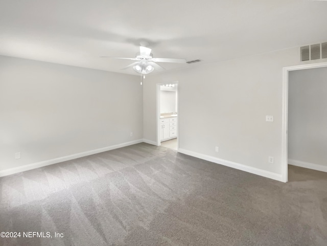 carpeted spare room featuring ceiling fan