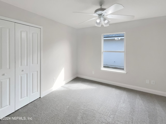 unfurnished bedroom with ceiling fan, carpet floors, and a closet