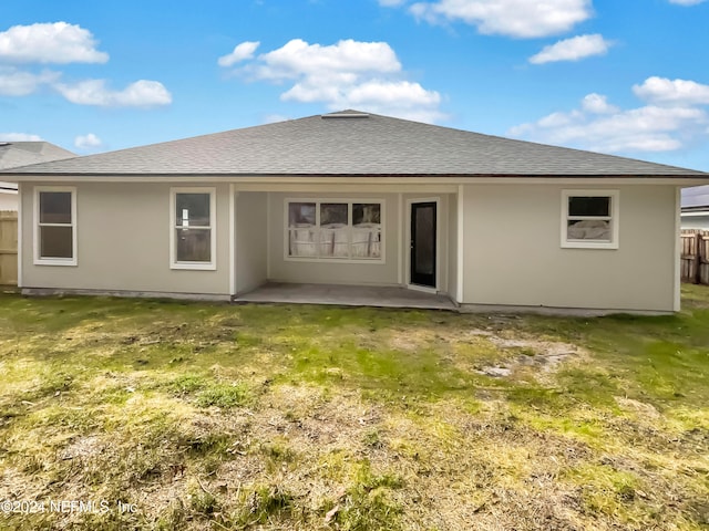 rear view of house with a patio area and a lawn