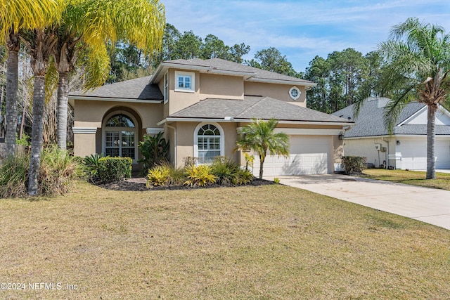 view of front property featuring a front lawn and a garage