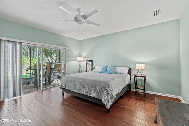 bedroom featuring a textured ceiling, access to exterior, ceiling fan, and dark hardwood / wood-style floors