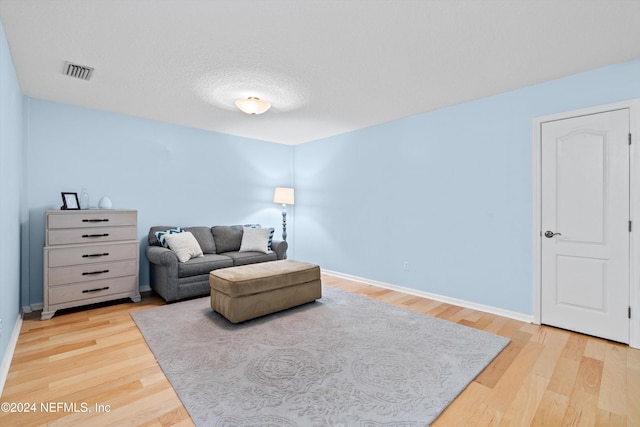 sitting room with a textured ceiling and hardwood / wood-style flooring