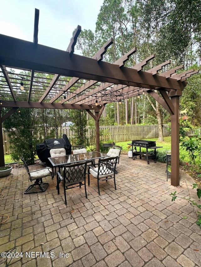 view of patio with a pergola and grilling area