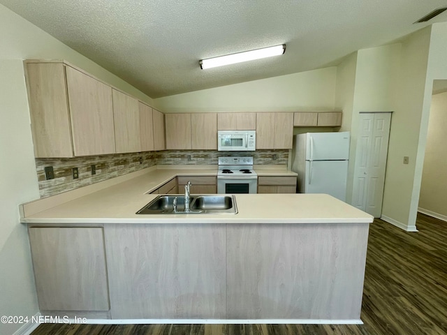 kitchen featuring sink, kitchen peninsula, lofted ceiling, white appliances, and light brown cabinetry