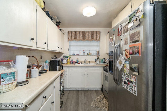 kitchen with sink, white cabinets, dark hardwood / wood-style floors, and appliances with stainless steel finishes