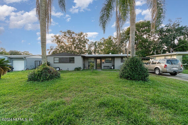 ranch-style home featuring a front yard and a garage