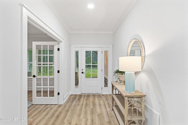 doorway featuring ornamental molding and light hardwood / wood-style floors