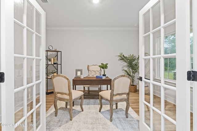 office area featuring french doors, ornamental molding, and light wood-type flooring